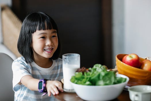 child pointing at a healthy plate