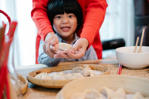 child helping in the kitchen with a parent